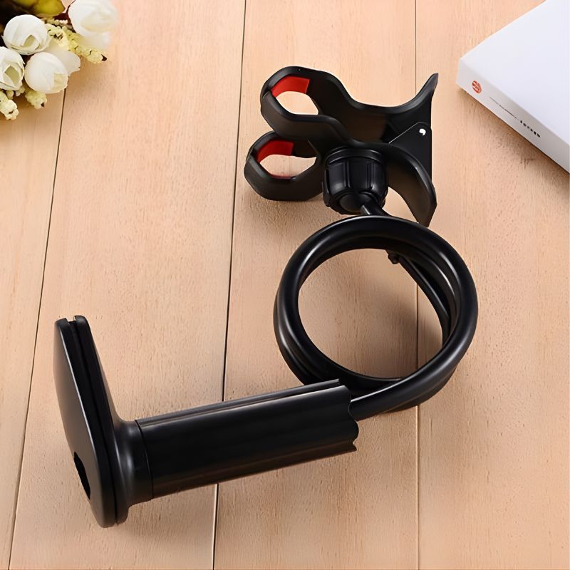 Black adjustable stand on a wooden surface with a blurred background