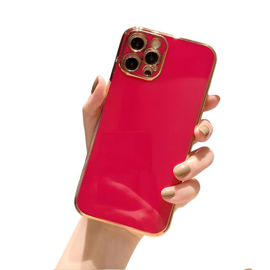 Hand holding a red phone case with gold trim against a white background