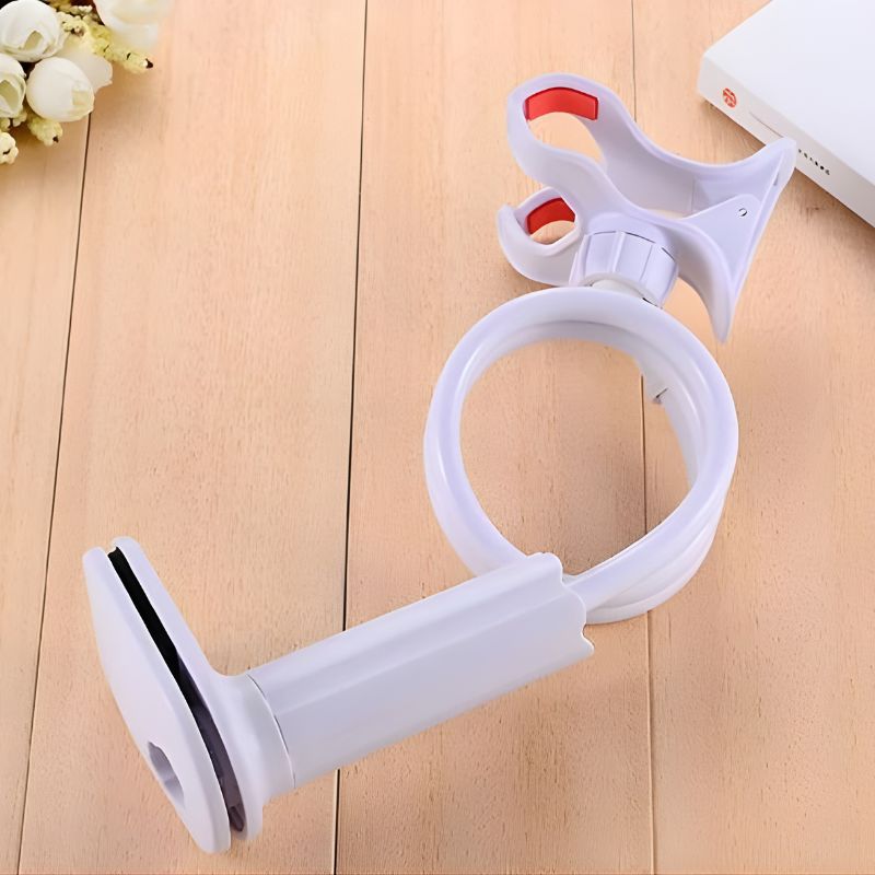 White flexible arm with a red clip on a wooden surface